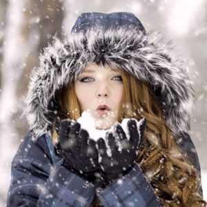 woman-blows-snow-from-gloves_large